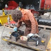 Alex Morton in the process of cleaning components of the locomotive, here the cartazzi axlebox top spring plates.